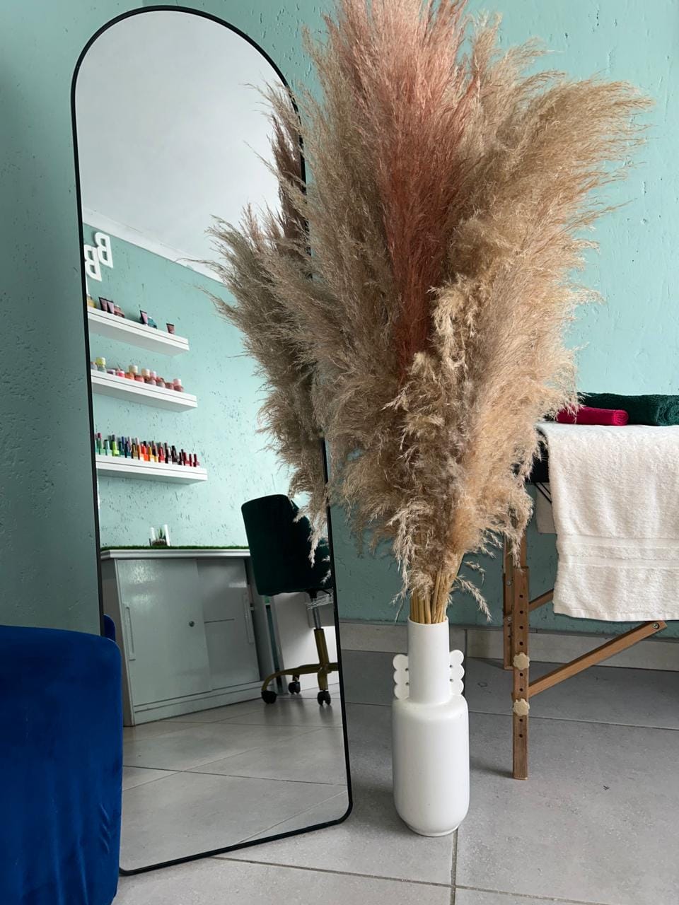 Mirror and pampas grass inside Bubbles Beauty Bar