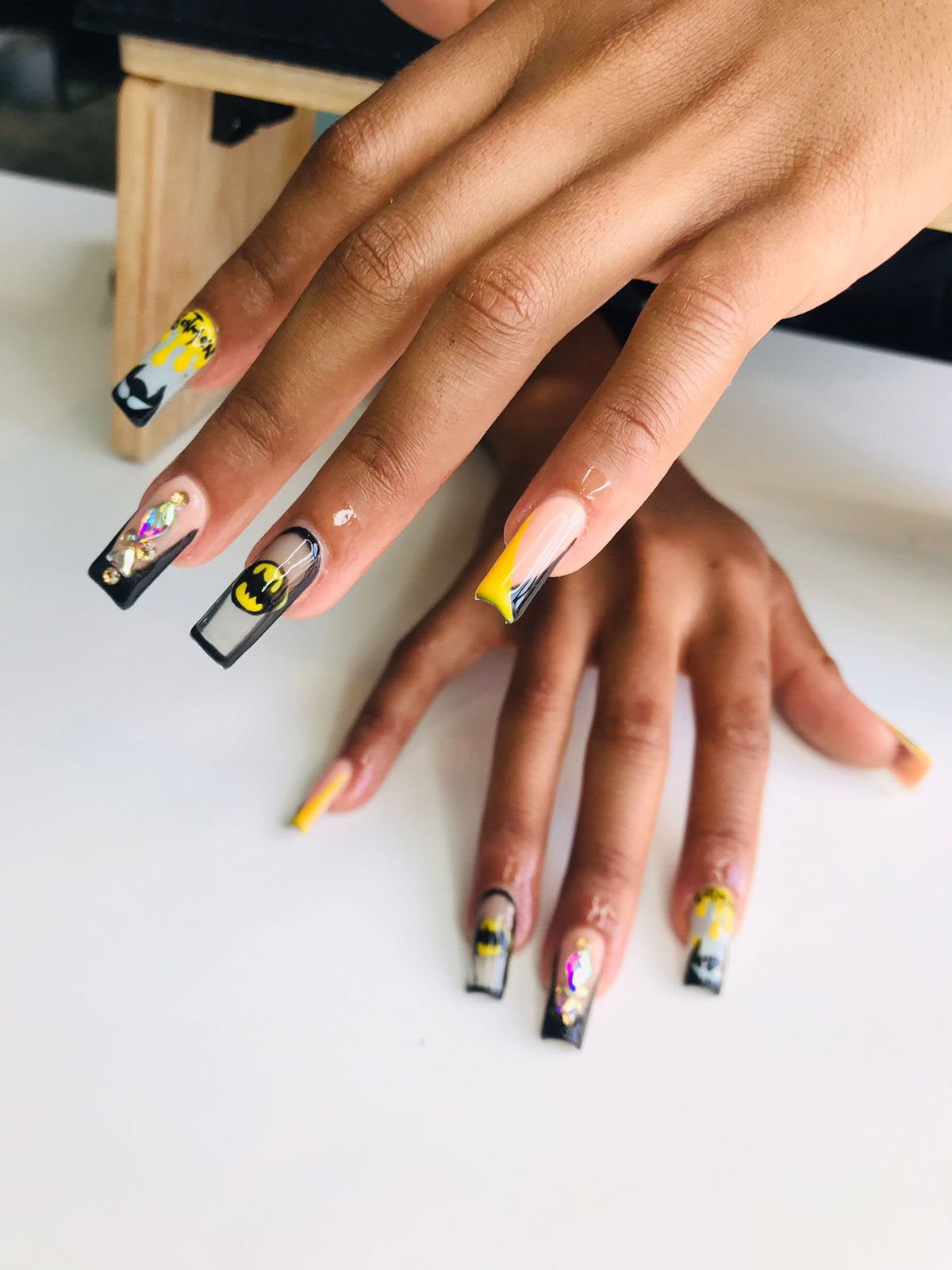 Black and yellow nail art created at Bubbles Beauty Bar
