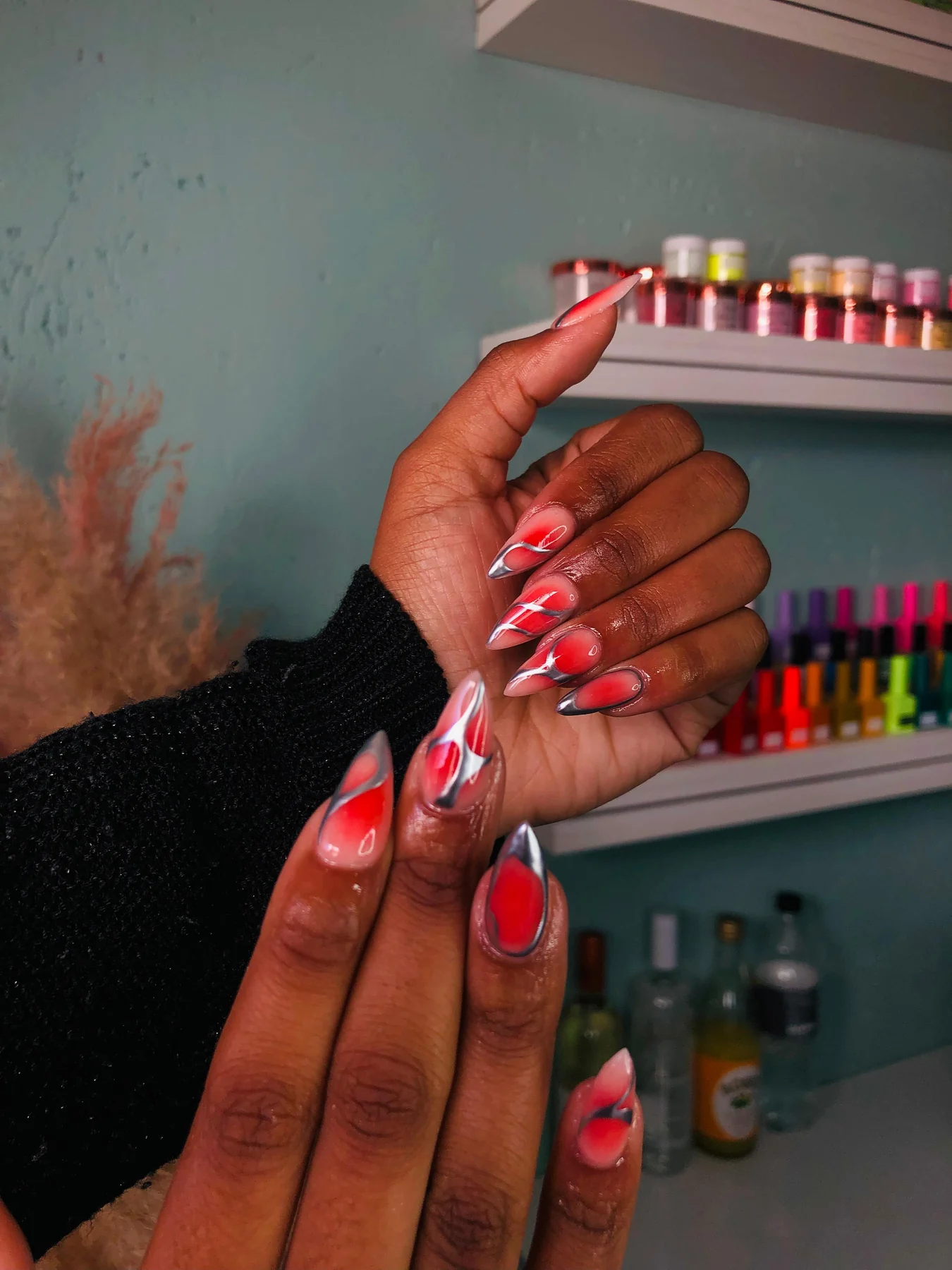 Red, black and white nail art created at Bubbles Beauty Bar